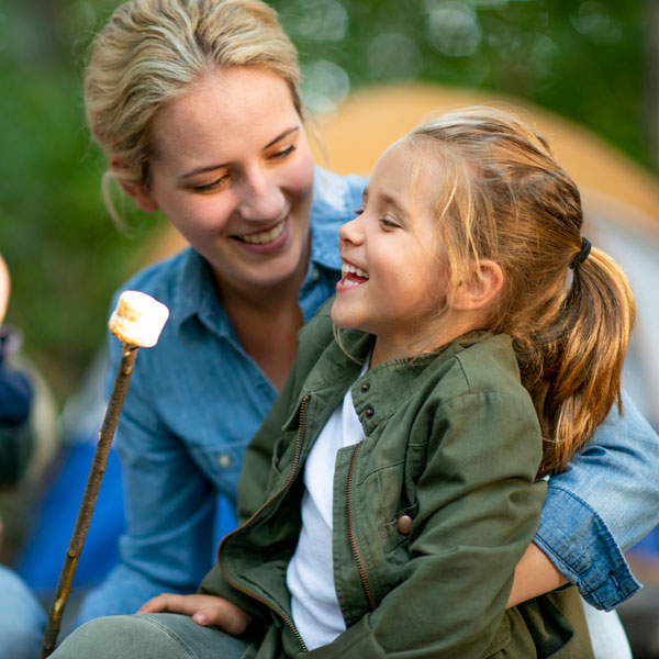 mother and daughter toasting marshmallow